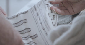 Video of a man and woman's hand holding and feeling the texture of the Sonoran Duvet Cover