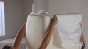 Video of two people sliding a Total Encasement Mattress Protector on a mattress then setting it on a bed frame and zipping the protector on