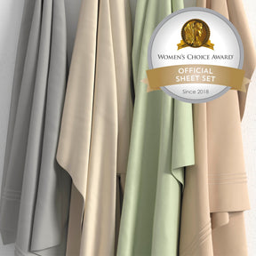 Image of all four color ways of Recovery Cotton Sheet Set hanging in order of Dove Gray, Ivory, Sage, Sand with a sticker in the top right corner saying "Women's Choice Award Official Sheet Set Since 2018"