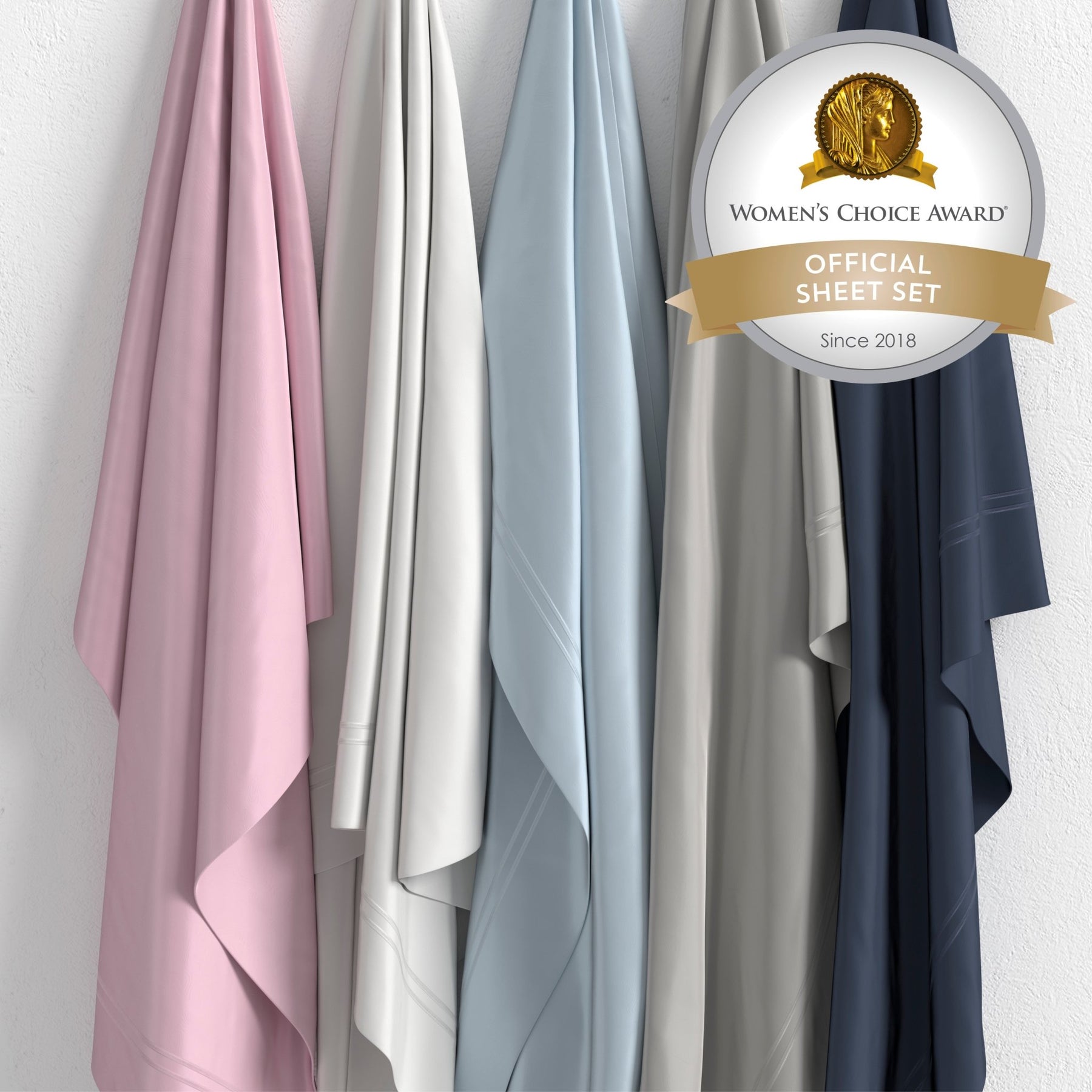 Image of all five color ways of Refreshing TENCEL™ Lyocell Sheet Set hanging in order of Lilac, White, Light Blue, Dove Gray, Celestial Blue with a sticker in the top right corner saying "Women's Choice Award Official Sheet Set Since 2018"