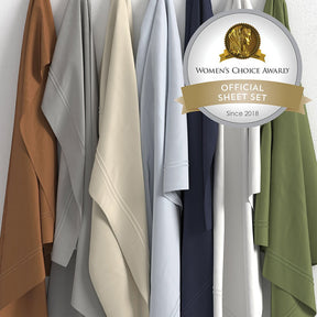 Image of all seven color ways of Soft Touch TENCEL™ Modal Sheet Set hanging in order of Clay, Dove Gray, Ivory, Light Blue, Midnight, White, and Moss with a sticker in the top right corner saying "Women's Choice Award Official Sheet Set Since 2018"
