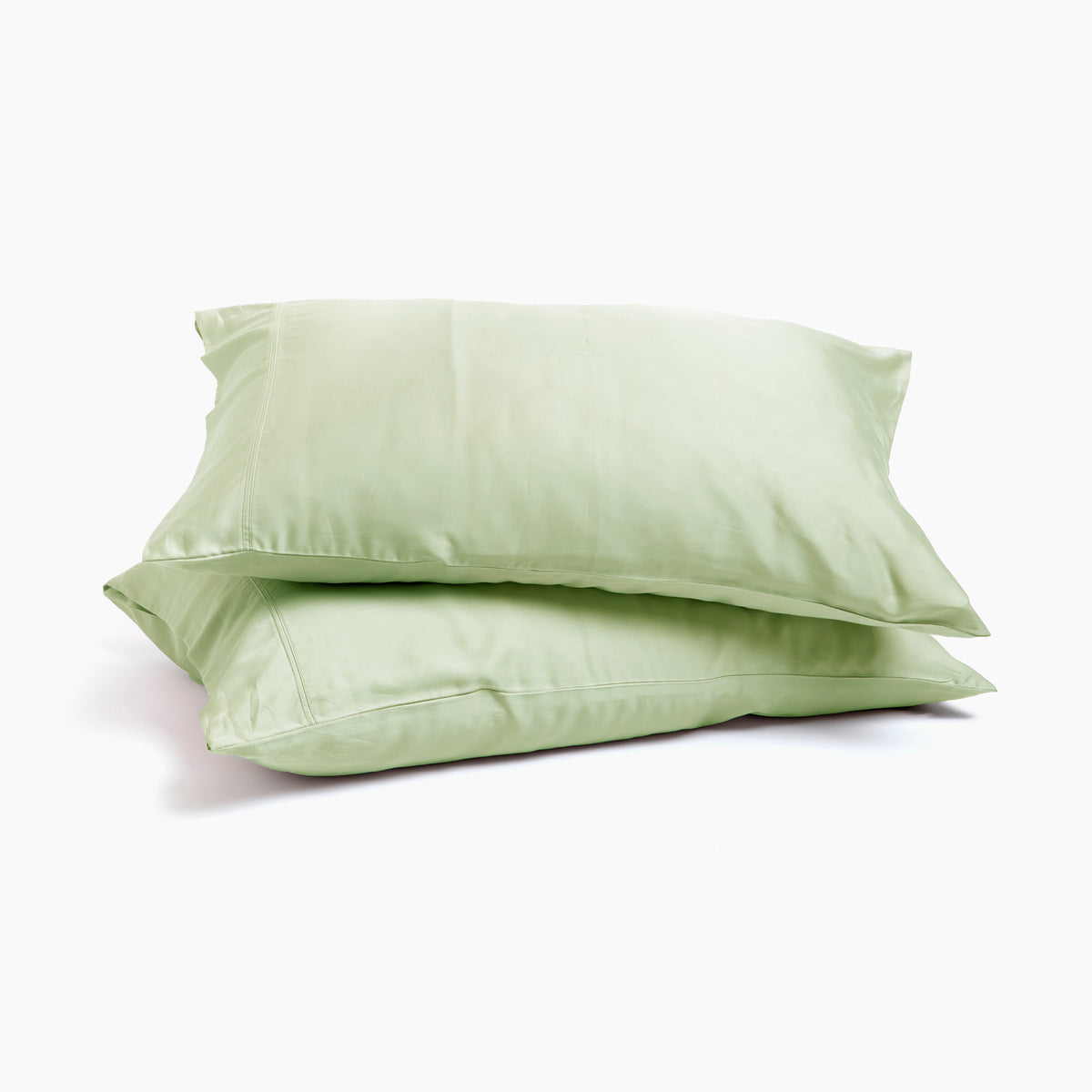 Image of two pillows stacked on top of one another with Sage Recovery Viscose Pillowcases on them with a white background
