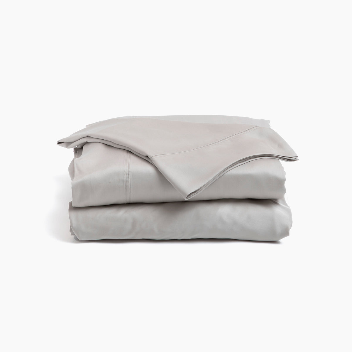 Image showcasing entire Dove Gray Recovery Viscose Sheet Set all neatly folded on top of one another with a white background. The image shows (from top to bottom): pillowcase, flat sheet, fitted sheet