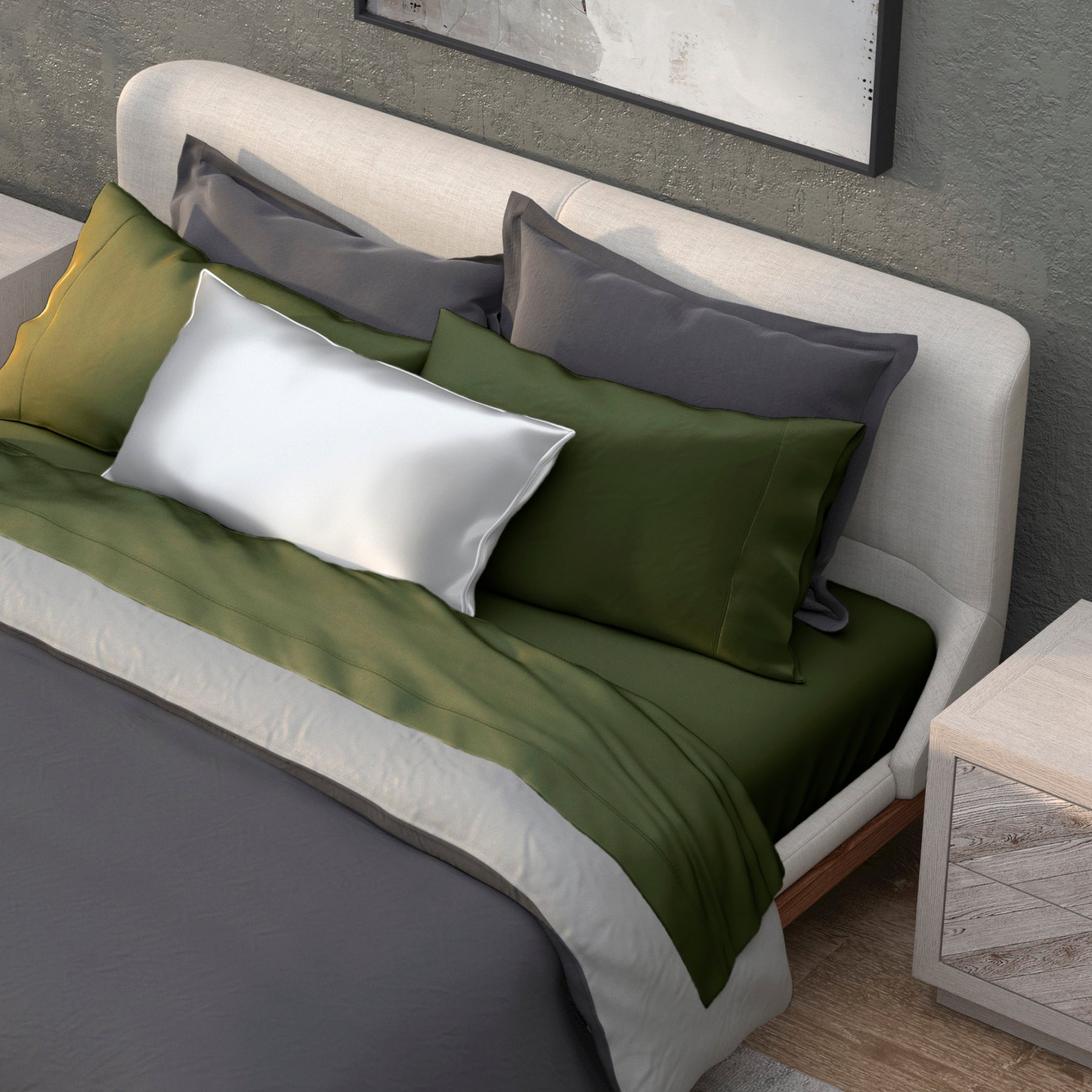 Image of a neatly made bed with a dark gray duvet and the Moss Recovery Viscose Sheet Set and Pillowcases