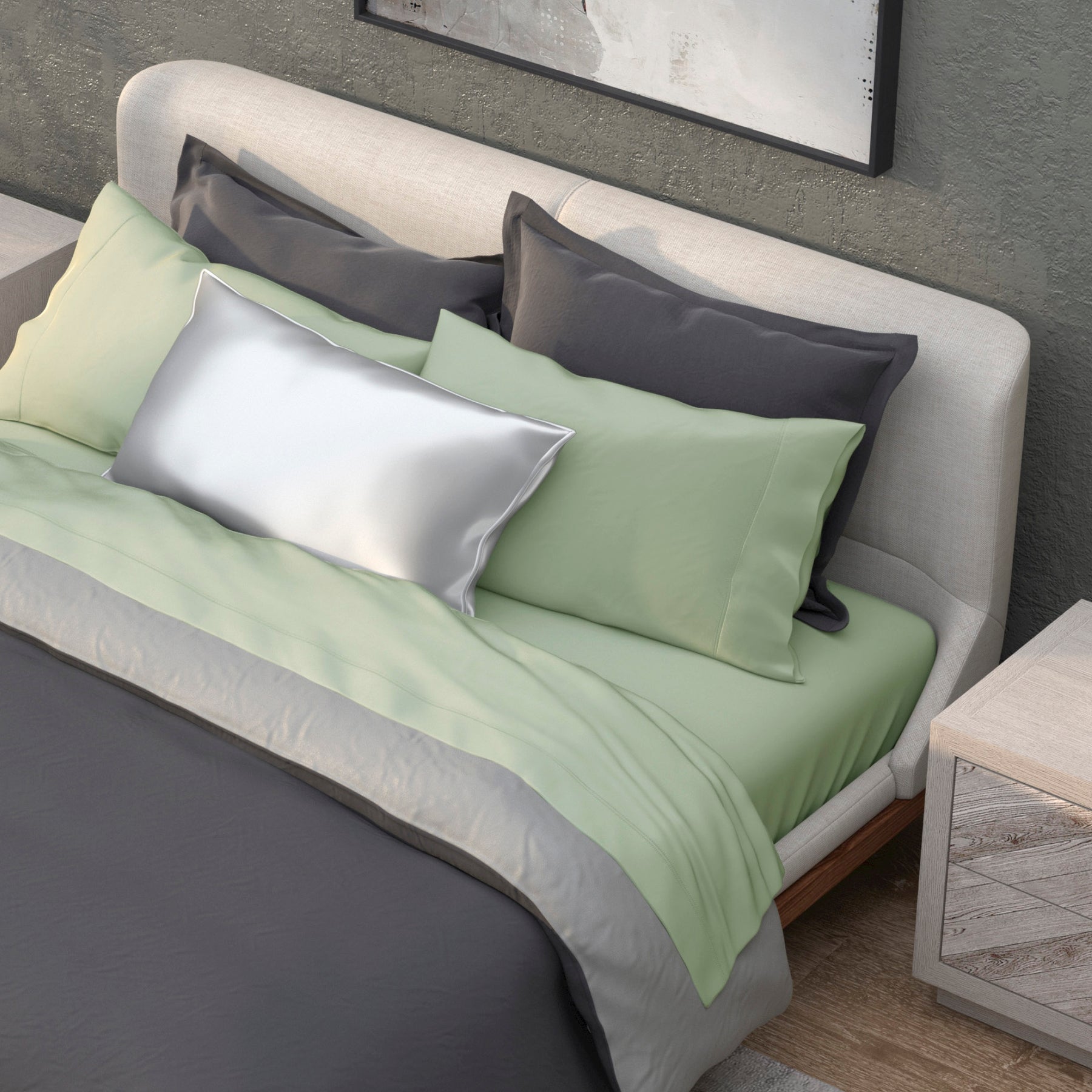 Image of a neatly made bed with a dark gray duvet and the Sage Recovery Viscose Sheet Set and Pillowcases