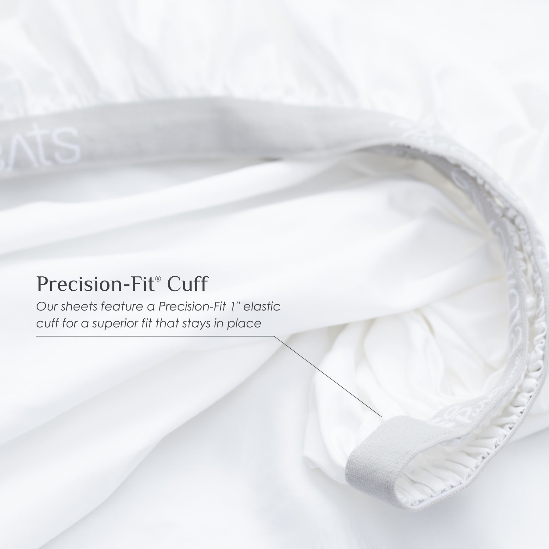 Image of a white fitted sheet showcasing the 1" elastic cuff on the bottom with text over the image reading: "Precision-Fit® Cuff Our sheets feature a Precision-Fit® 1" elastic cuff for a superior fit that stays in place"