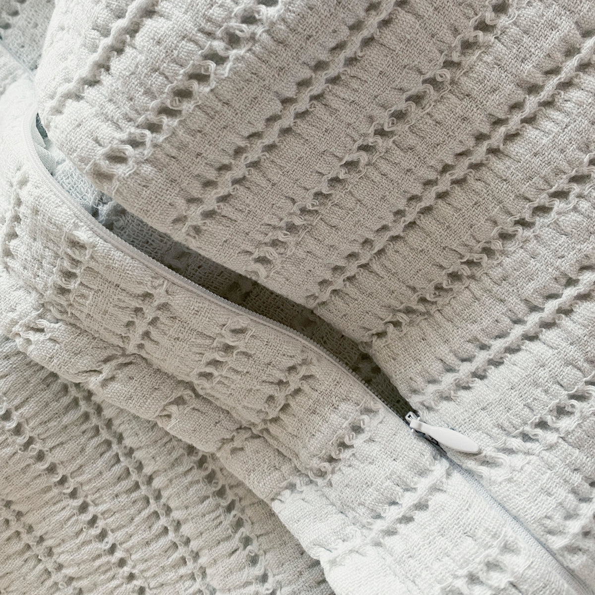 Close-up image of the Ecru Ridgeback Pillow Sham showcasing the zipper 