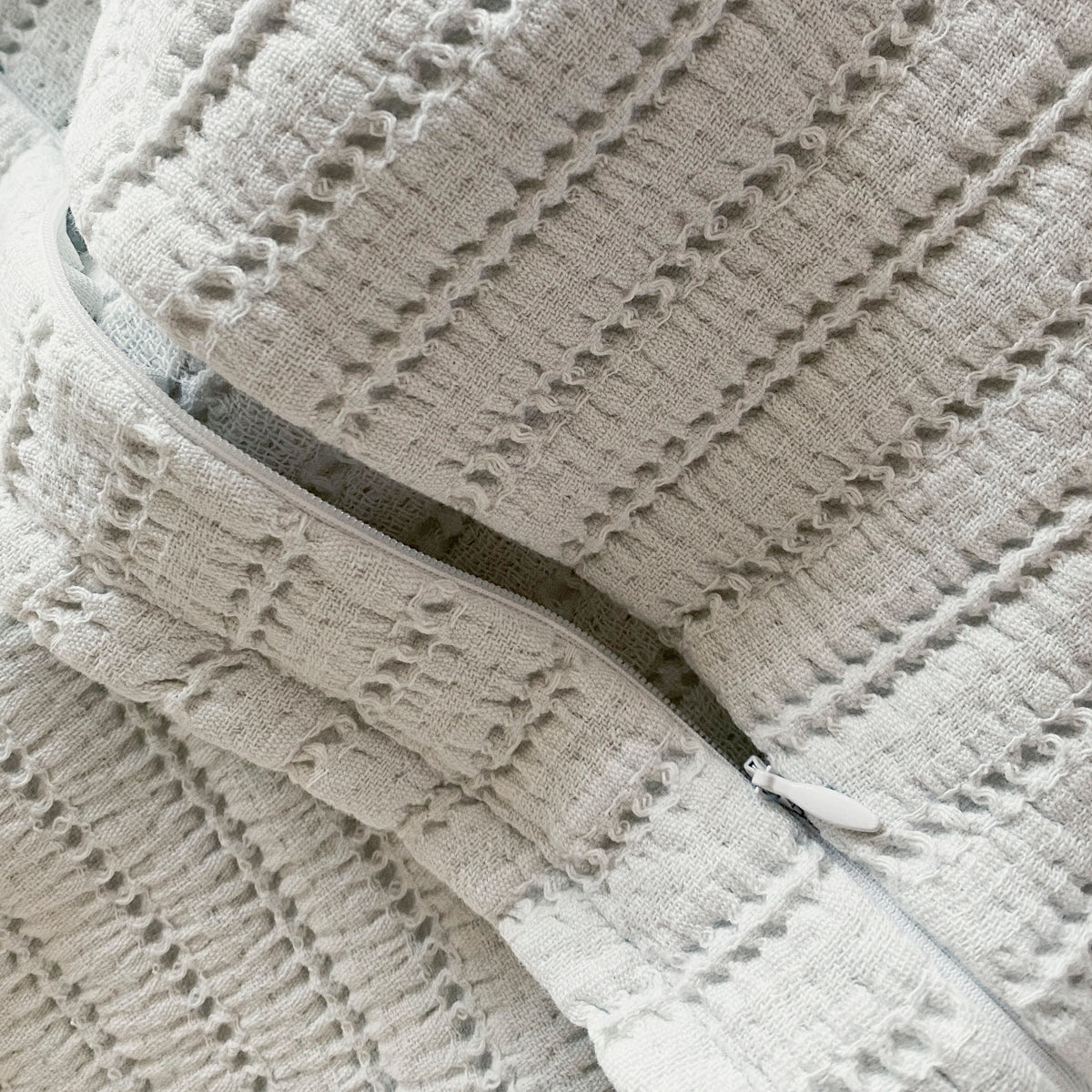 Close-up image of the Ecru Ridgeback Pillow Sham showcasing the zipper