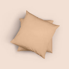 Image of the top of the Ochre Euro-sized Garment Washed Percale Pillow Sham on two Euro pillows stacked on top of one another with a light pink background