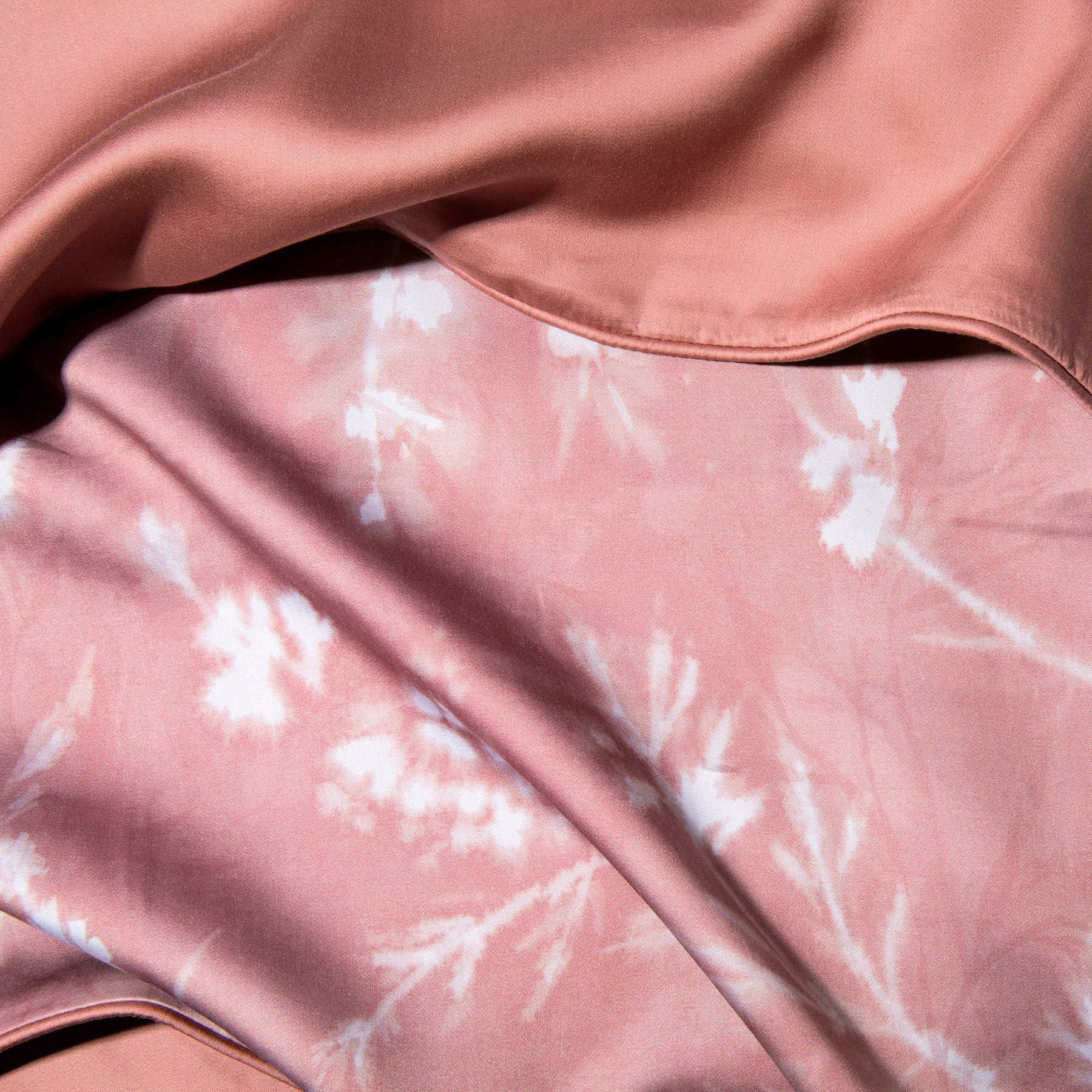 Close-up image of the Floral Ash Rose Duvet Cover + Cooling showcasing both the Floral Ash Rose side and the reversible plain Ash Rose side