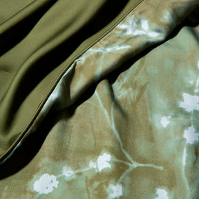Close-up image of the Floral Evergreen Duvet Cover + Cooling showcasing both the Floral Evergreen side and the reversible plain Evergreen side