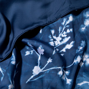 Close-up image of the Floral Midnight Duvet Cover + Cooling showcasing both the Floral Midnight side and the reversible plain Midnight side