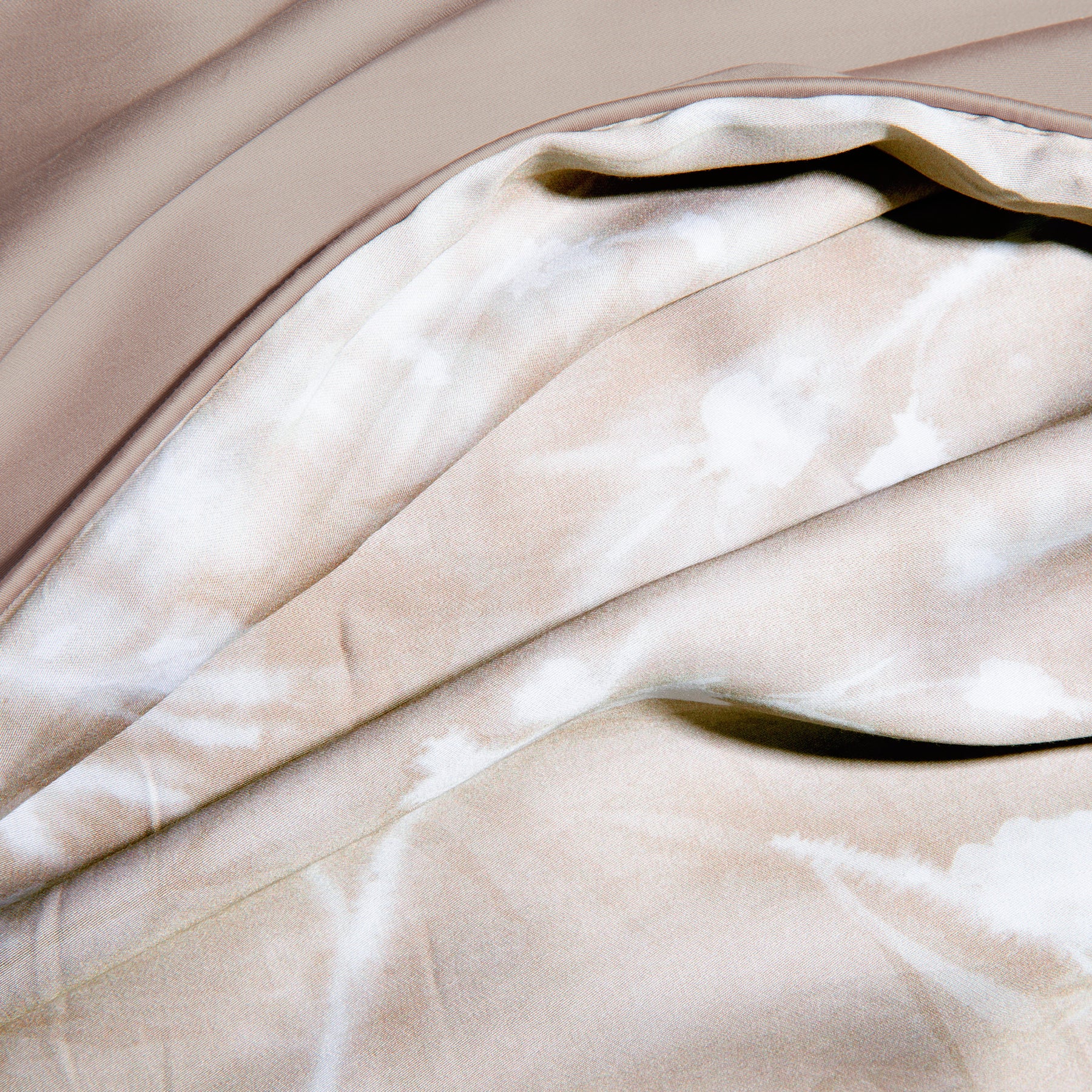 Close-up image of the Floral Oatmeal Duvet Cover + Cooling showcasing both the Floral Oatmeal side and the reversible plain Oatmeal side