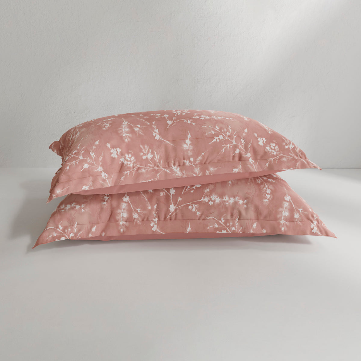Image of two Floral Ash Rose Pillow Shams on pillows stacked on top of each other with a white background