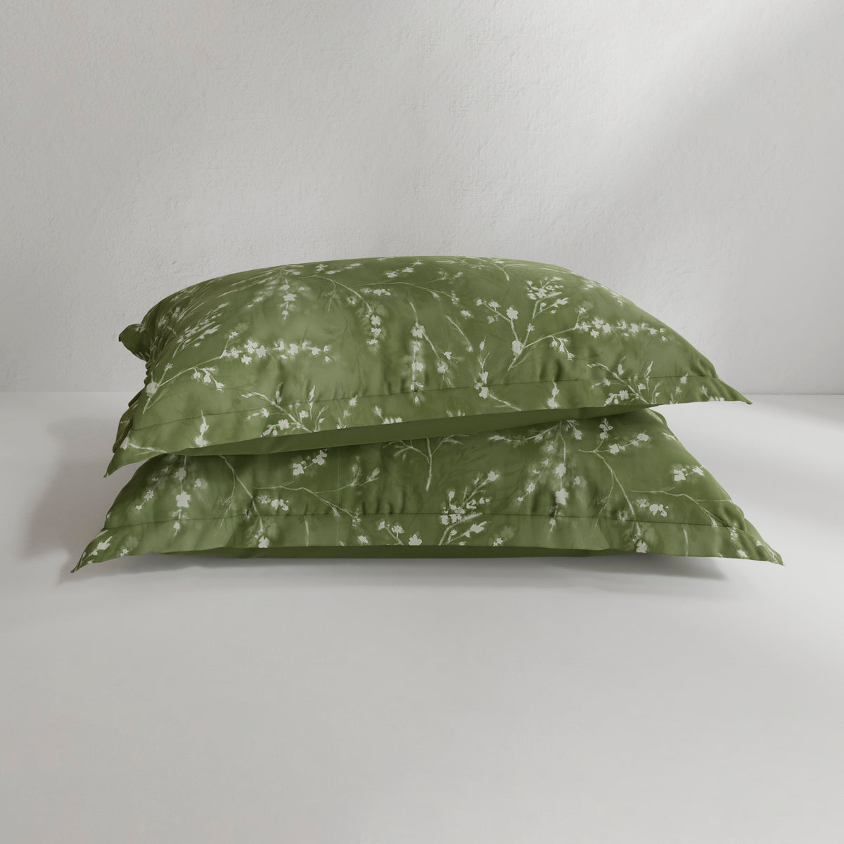 Image of two Floral Evergreen Pillow Shams on pillows stacked on top of each other with a white background