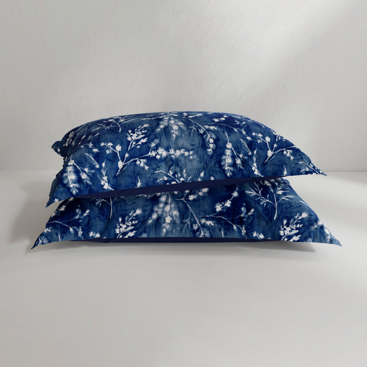 Image of two Floral Midnight Pillow Shams on pillows stacked on top of each other with a white background
