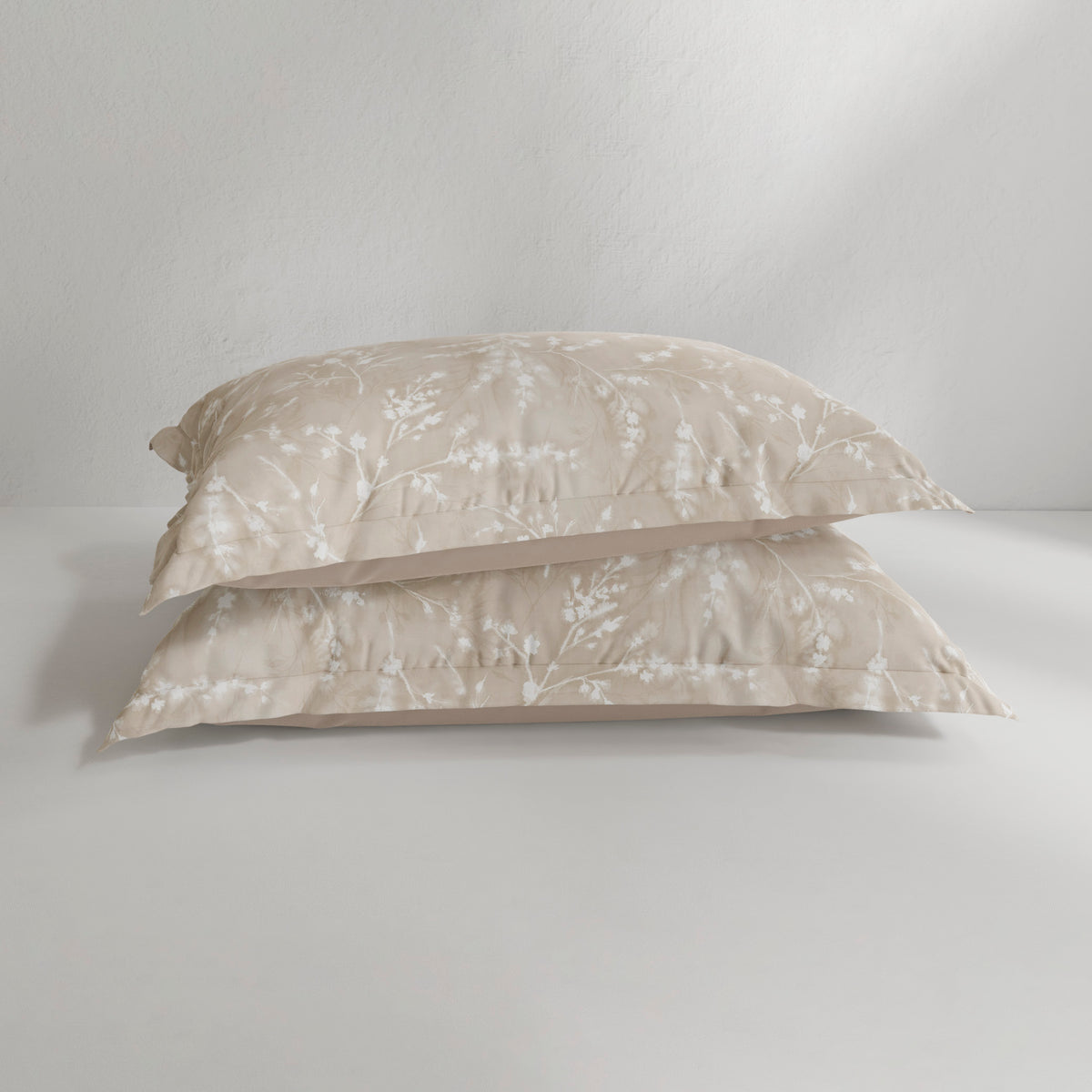 Image of two Floral Oatmeal Pillow Shams on pillows stacked on top of each other with a white background
