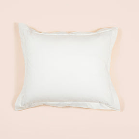 Image of the reverse white side of a Sonoran Pillow Sham on a Euro pillow with a light pink background