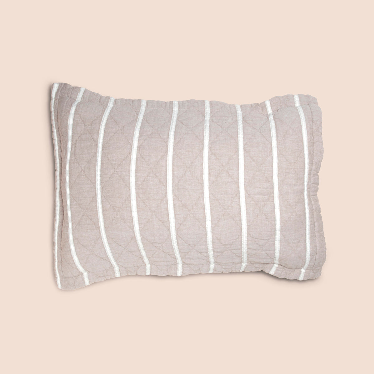 Image of the gray and white side of the Heritage Pillow Sham on a pillow with a light pink background
