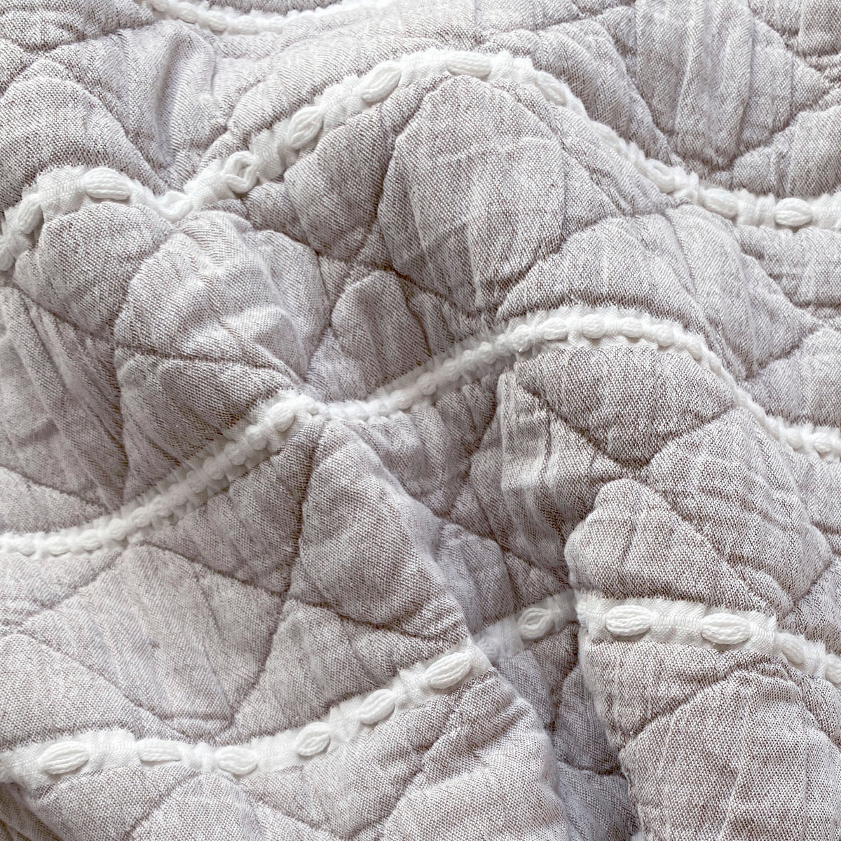 Close-up image of the gray and white striped side of the Heritage Quilt