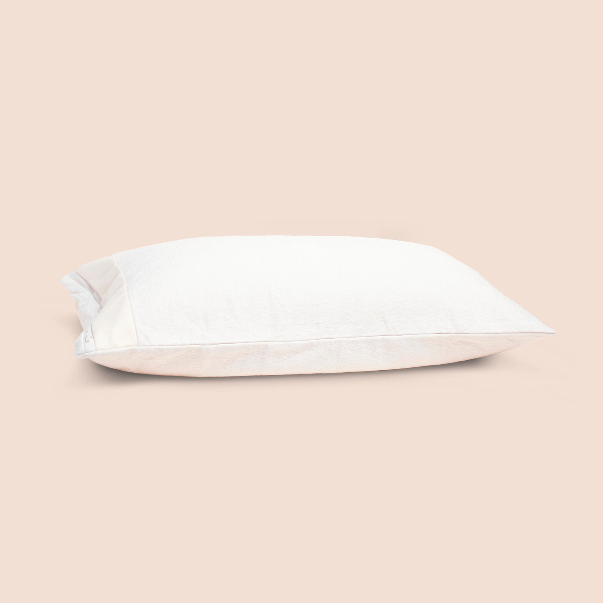 Image of the Signature Pillow Protector on a pillow with a light pink background
