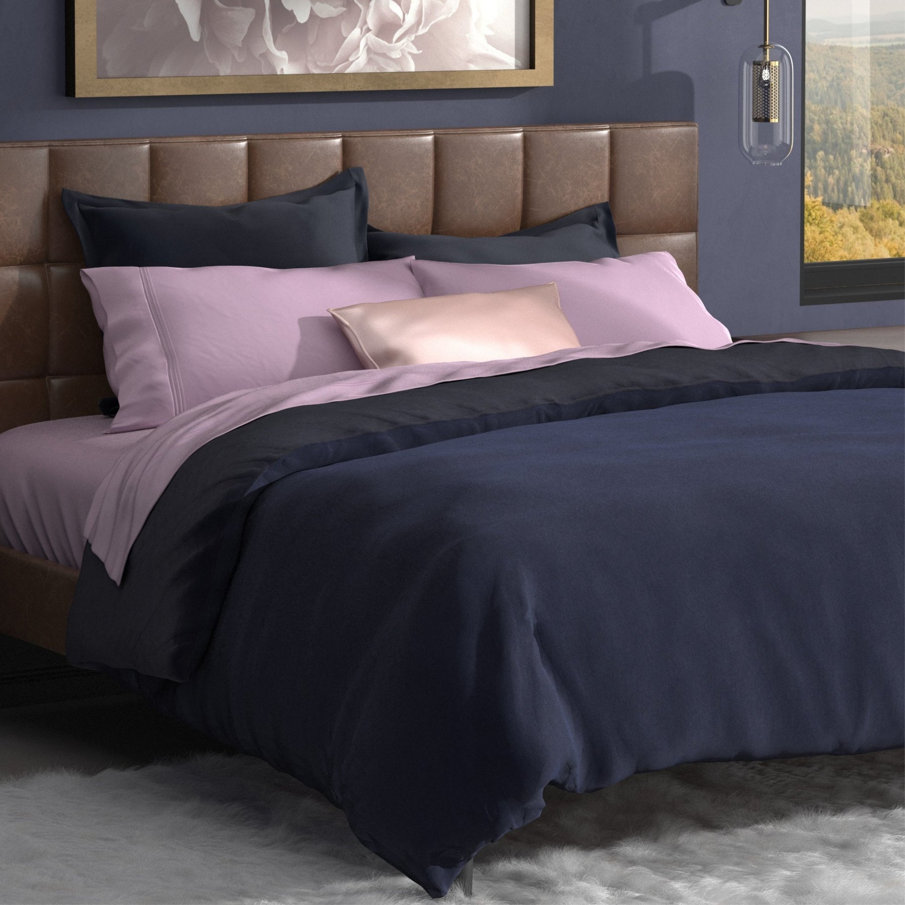 Image of a neatly made bed with lilac-colored sheets and the Midnight/Celestial Duvet Cover + Cooling on top with the Midnight side facing up