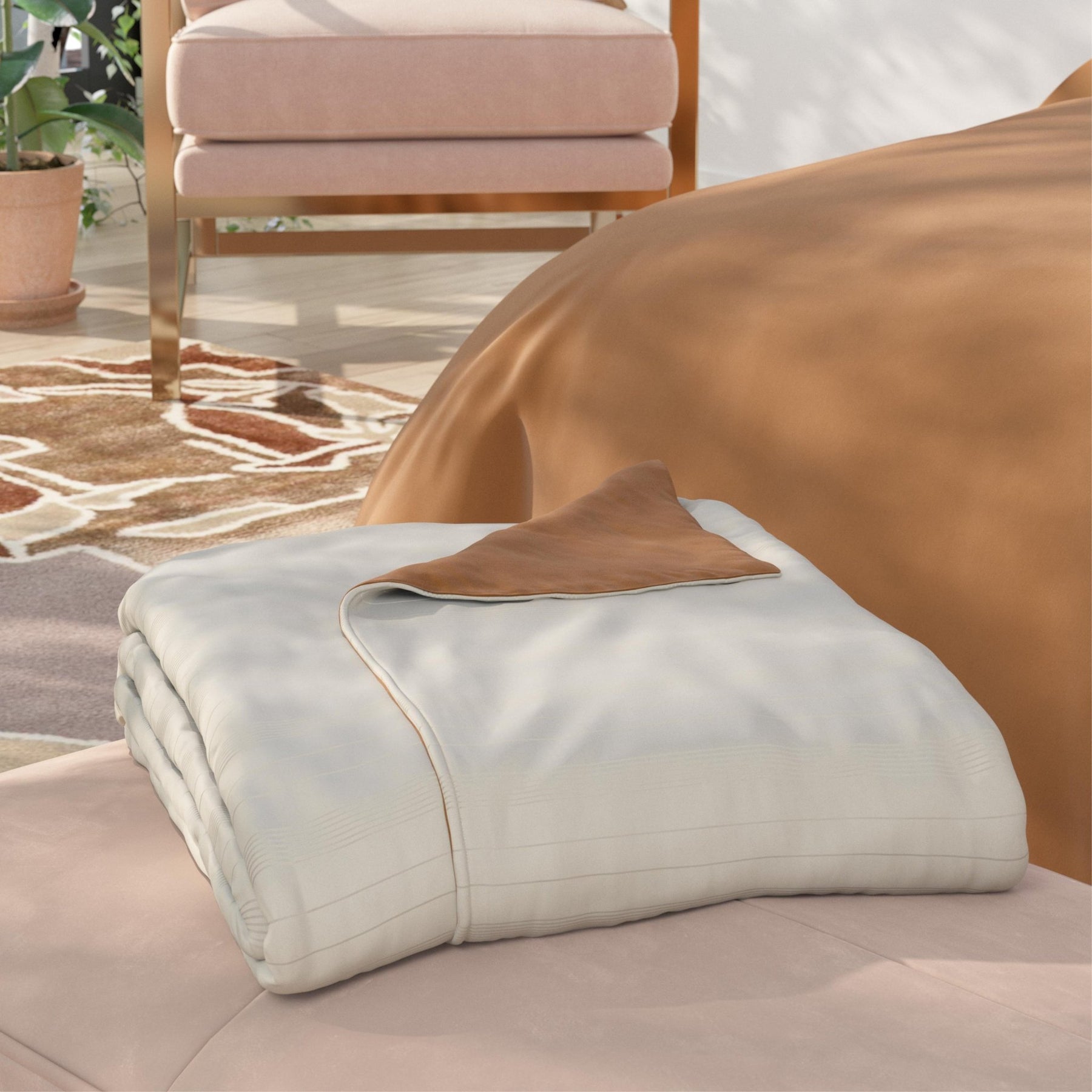 Image of a neatly folded Ivory/Clay Duvet Cover + Cooling with the Ivory side facing up and a corner of the clay side folded back on a light pink stool at the foot of a bed