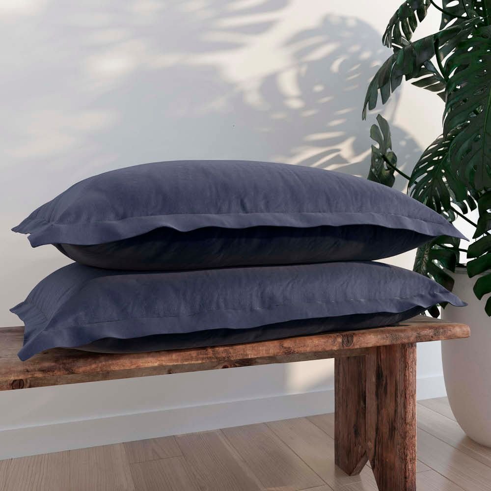 Image of two Midnight/Celestial Pillow Shams + Cooling on pillows stacked on a wooden bench