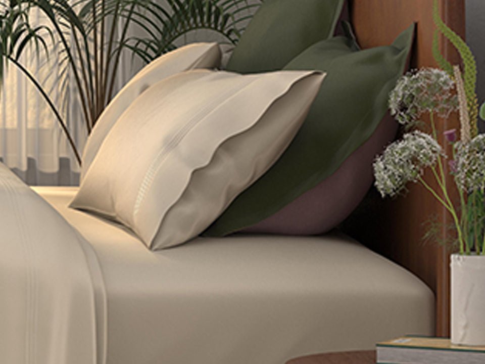 Image of a bed with ivory sheets and the Lilac/Jungle Pillow Shams + Cooling with the Jungle side facing up