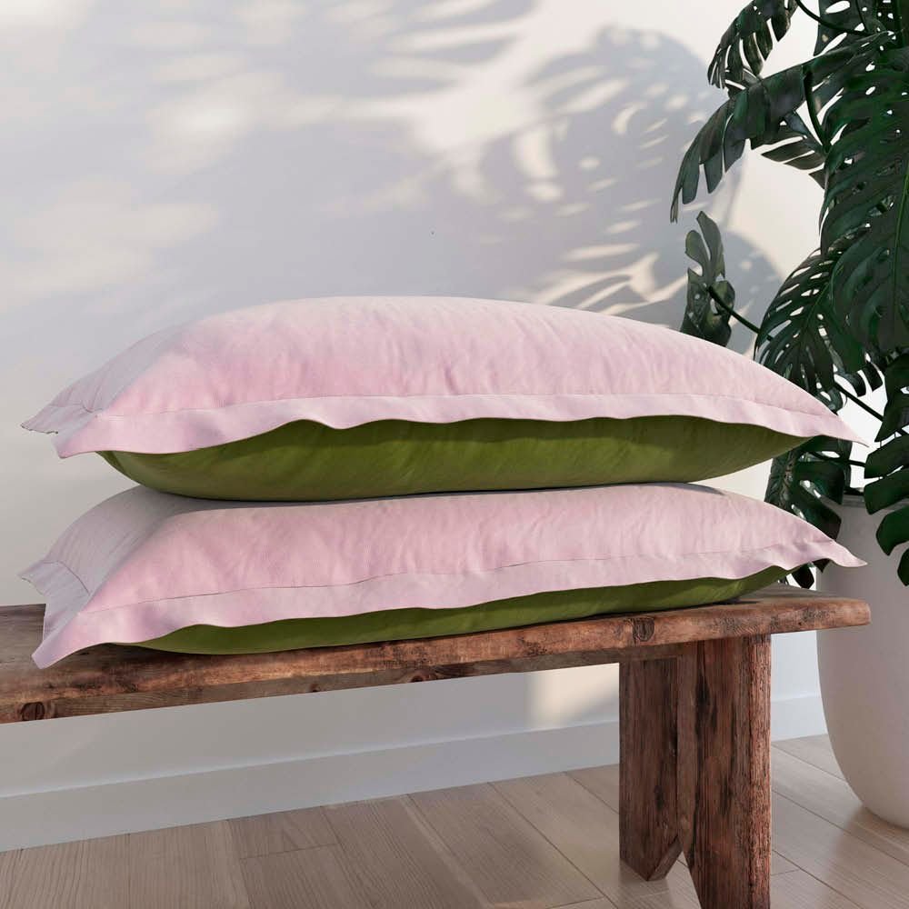 Image of two Lilac/Jungle Pillow Shams + Cooling on pillows stacked on a wooden bench