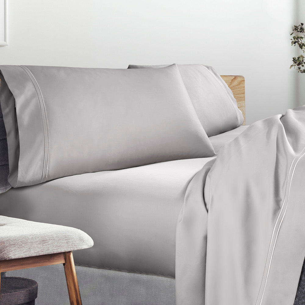 Image of a lived-in bed with a Dove Gray Refreshing TENCEL™ Lycocell Sheet Set on it