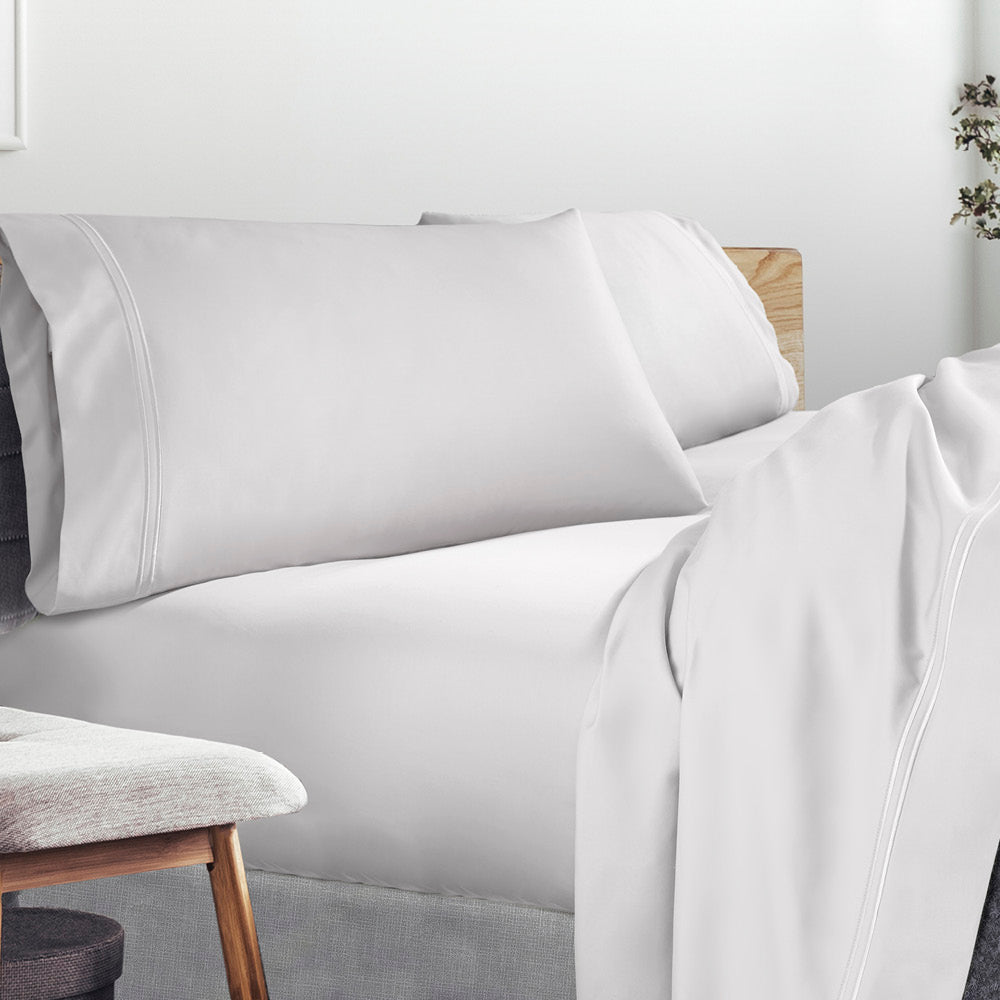 Image of a lived-in bed with a White Refreshing TENCEL™ Lycocell Sheet Set on it
