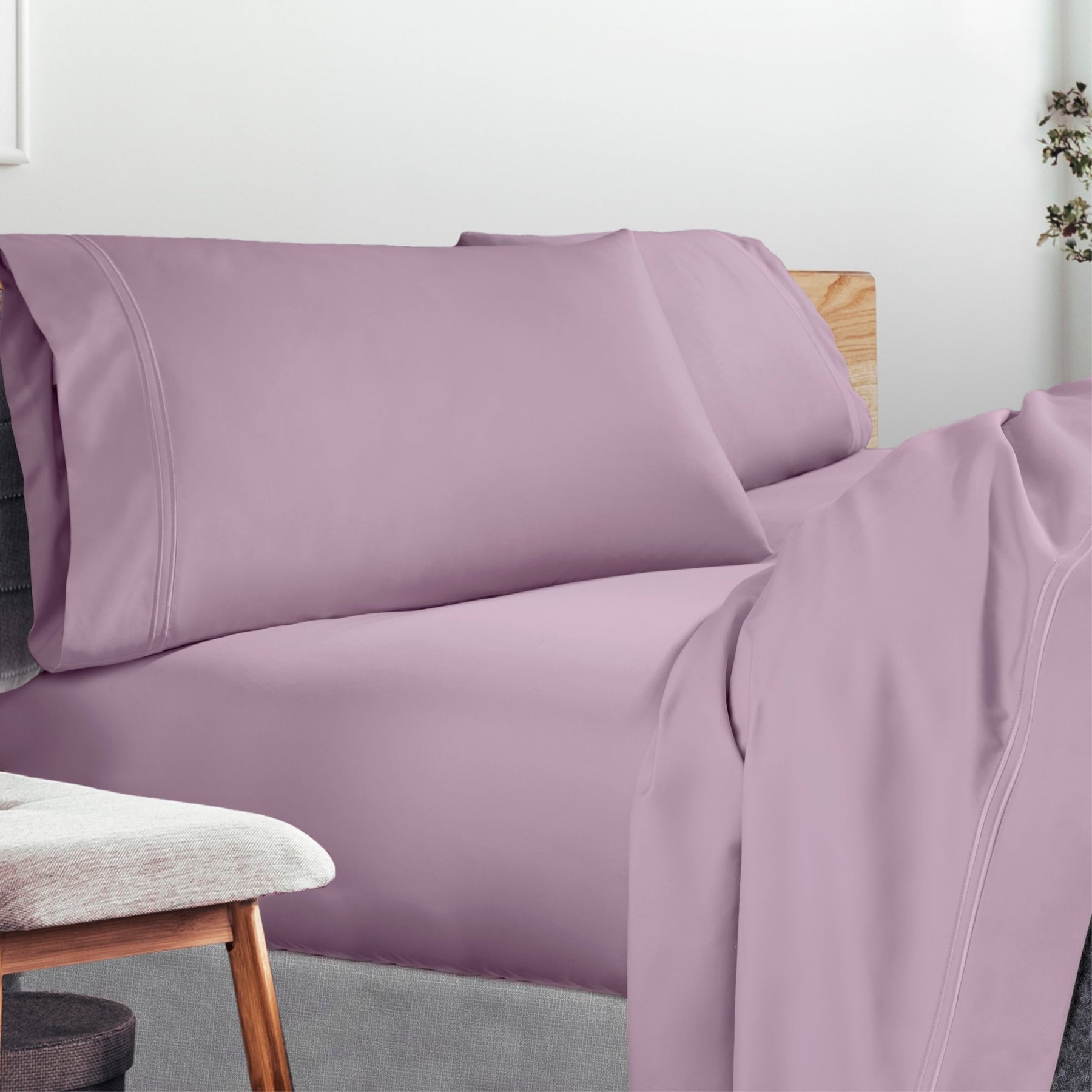 Image of a lived-in bed with a Lilac Refreshing TENCEL™ Lycocell Sheet Set on it