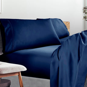 Image of a lived-in bed with a Celestial Blue Refreshing TENCEL™ Lycocell Sheet Set on it