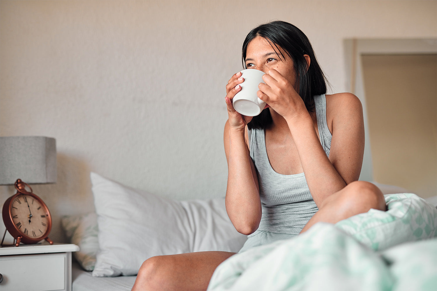 woman waking up with coffee in bed