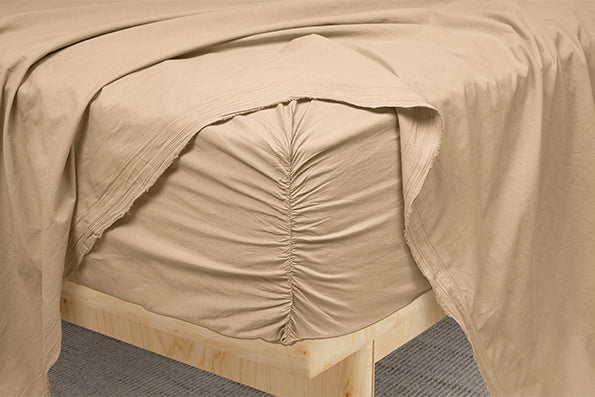 Image of Ochre Garment Washed Percale fitted sheet showcasing the Precision-Fit® Corner on the edge of a mattress