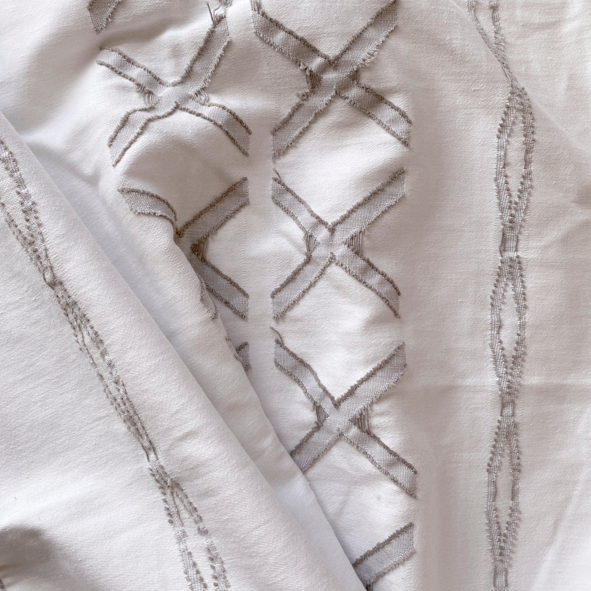 Close-up image of the Sonoran Duvet Cover showcasing the unique textured X design