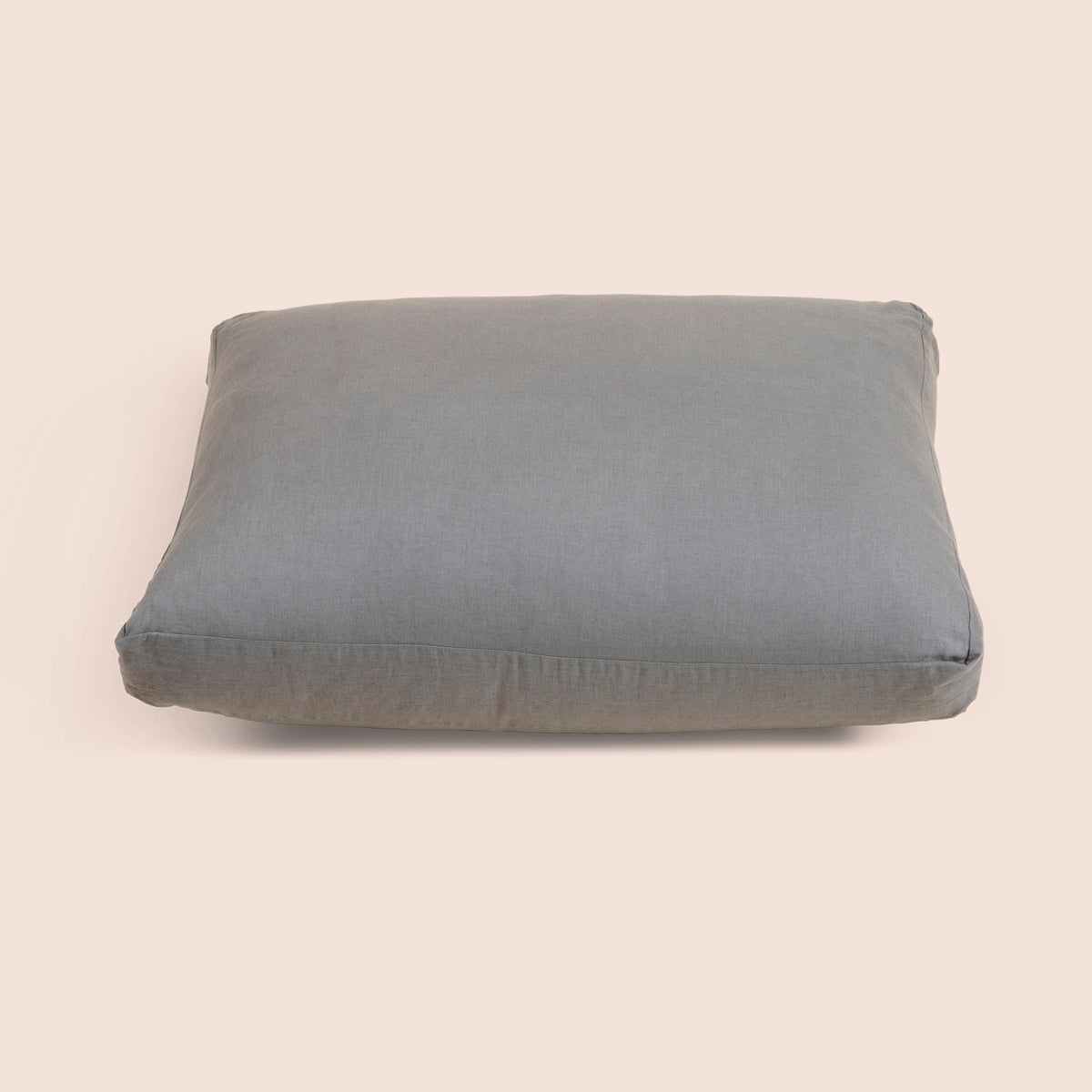 Image of Stone Gray Blended Linen Meditation Cushion Cover on a meditation cushion with a light pink background