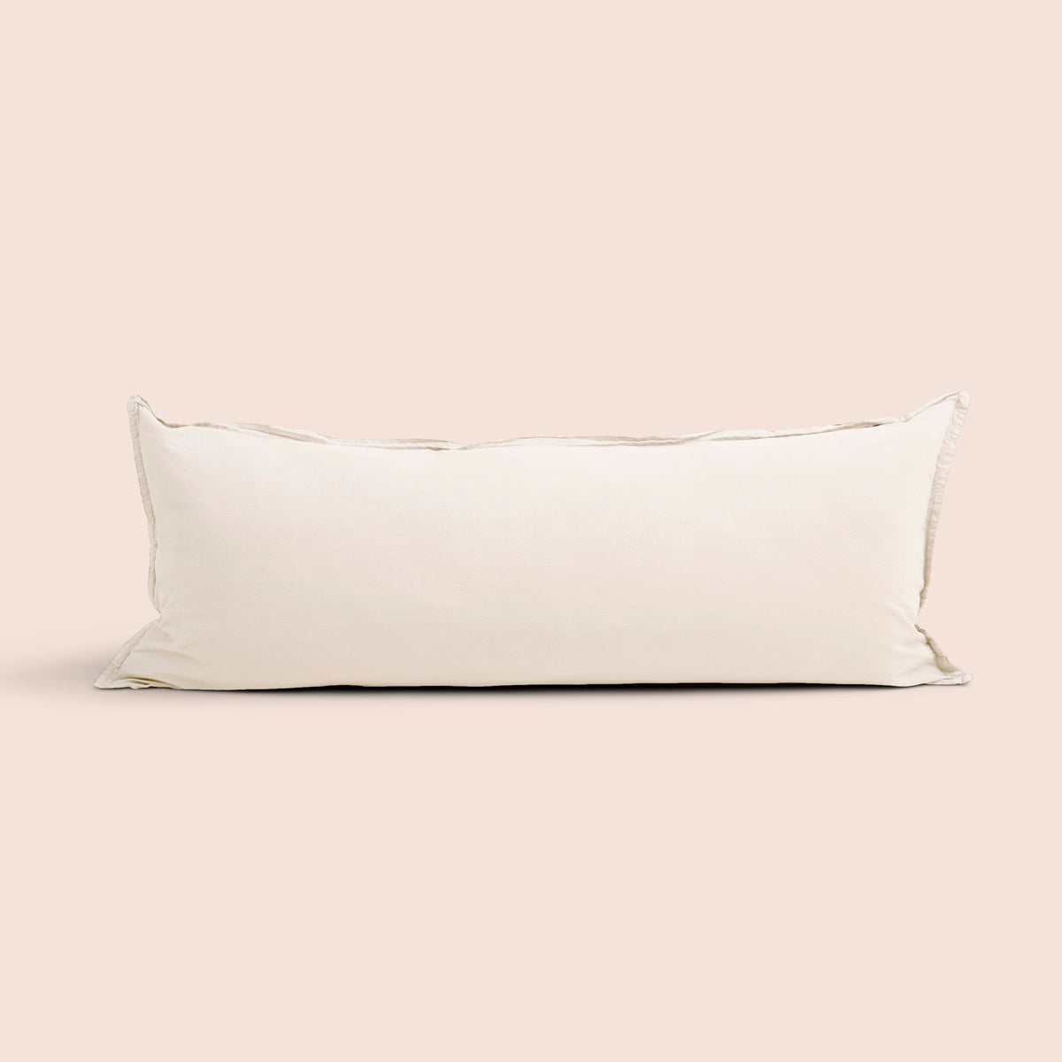 Image of Ecru Garment Washed Percale Lumbar Pillow Cover on a lumbar pillow with a light pink background