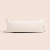 Image of Ecru Garment Washed Percale Lumbar Pillow Cover on a lumbar pillow with a light pink background