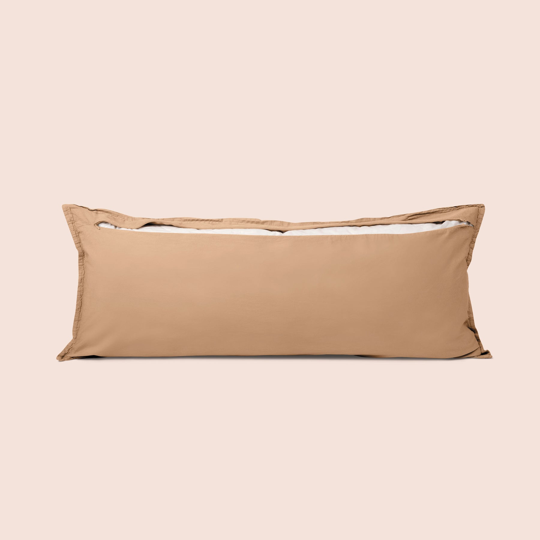 Image of the back of the Ochre Garment Washed Percale Lumbar Pillow Cover on a lumbar pillow with the back zipper open on a light pink background