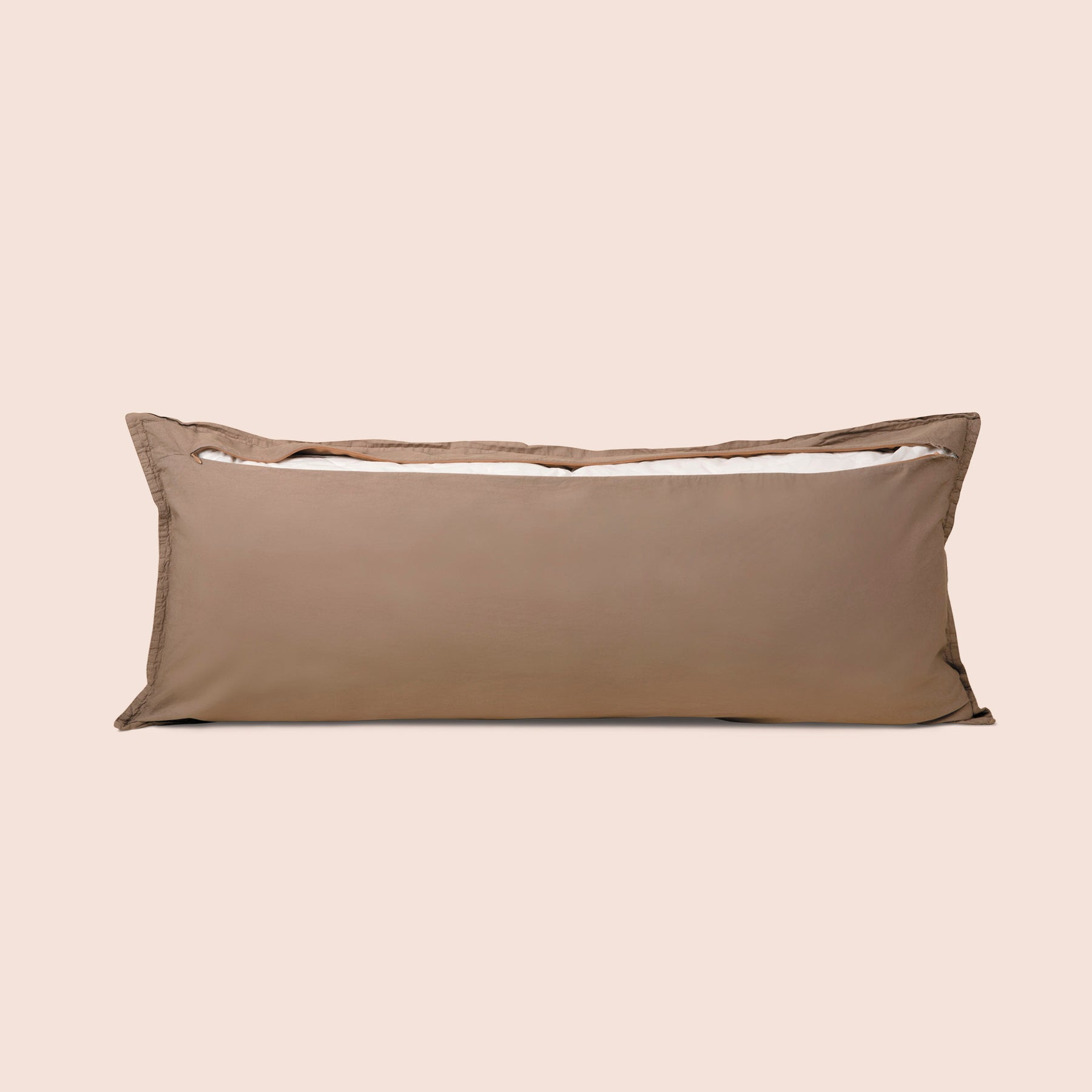 Image of the back of the Desert Sand Garment Washed Percale Lumbar Pillow Cover on a lumbar pillow with the back zipper open on a light pink background