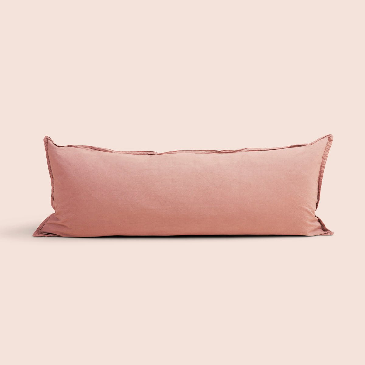 Image of Pink Sandstone Garment Washed Percale Lumbar Pillow Cover on a lumbar pillow with a light pink background