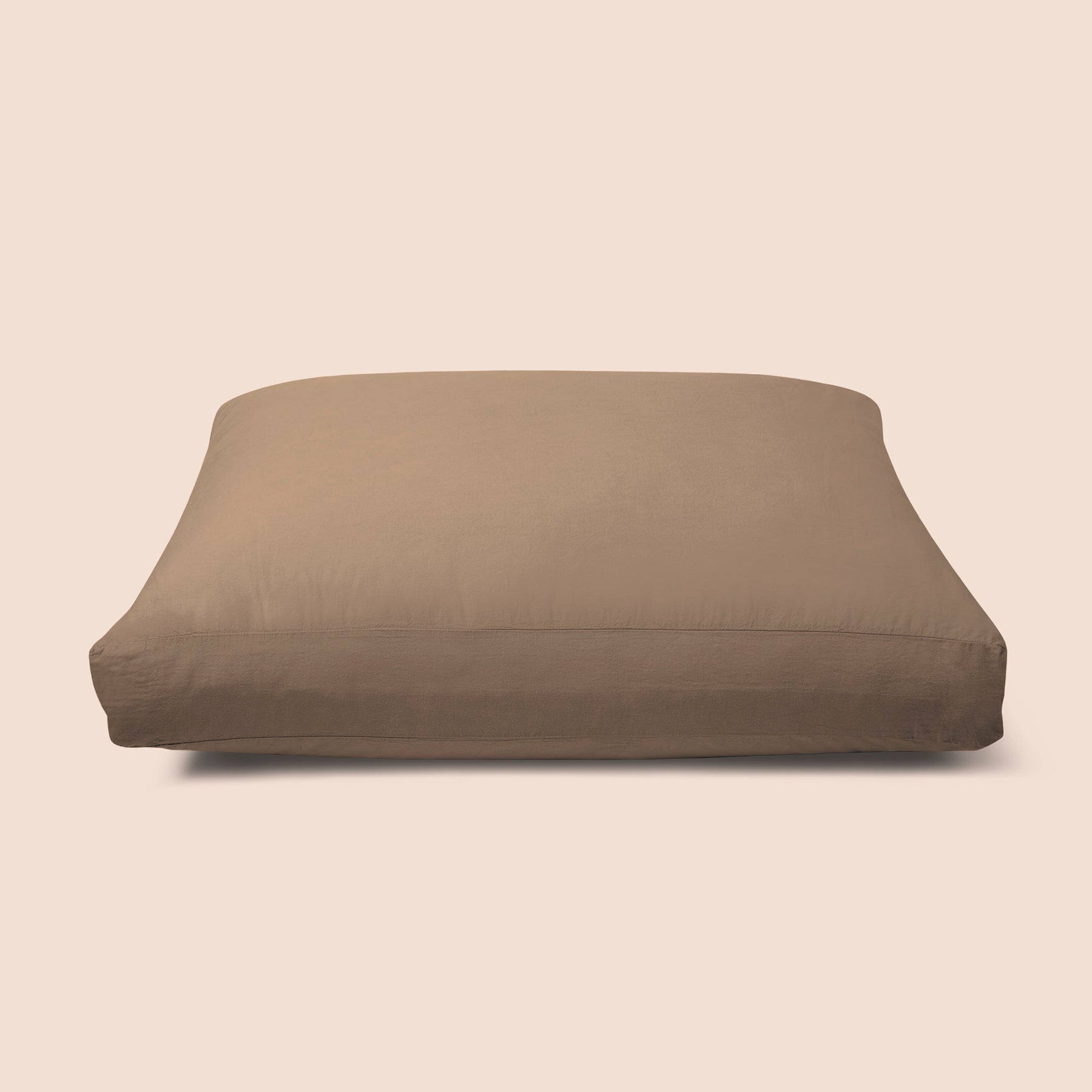 Image of Desert Sand Garment Washed Percale Meditation Cushion Cover on a meditation cushion with a light pink background