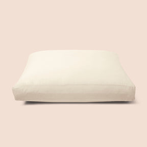 Image of Ecru Garment Washed Percale Meditation Cushion Cover on a meditation cushion with a light pink background