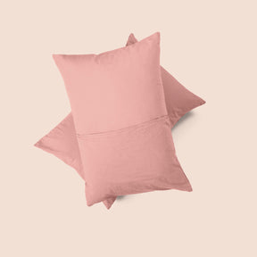 Image of the back of the Pink Sandstone Garment Washed Percale Pillow Sham on two pillows stacked on top of one another with a light pink background