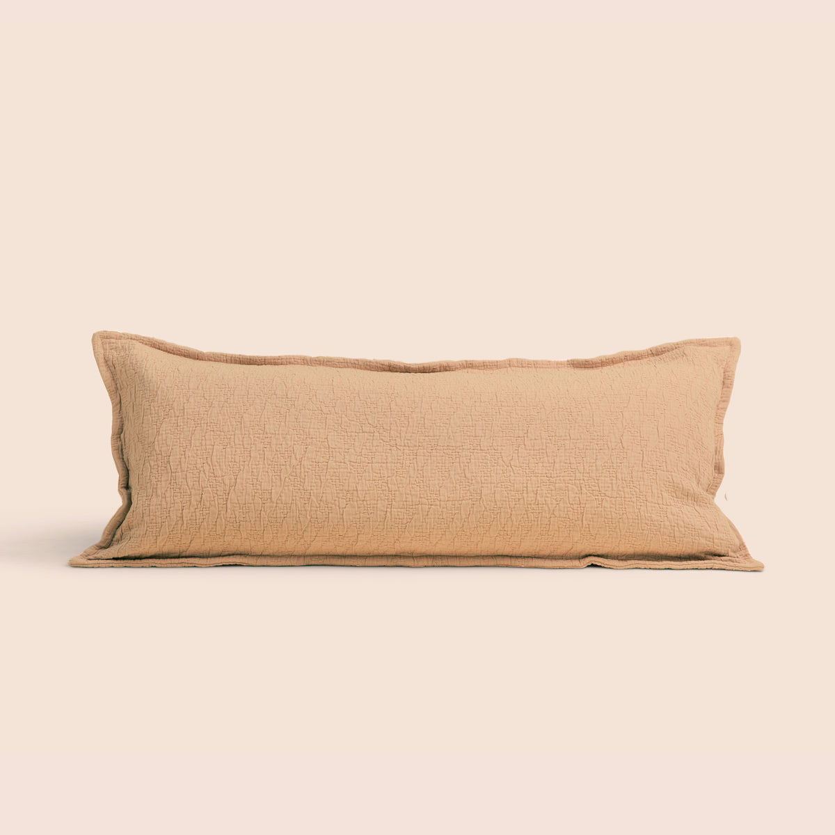 Image of an Ochre Wave Lumbar Pillow Cover on a lumbar pillow with a light pink background