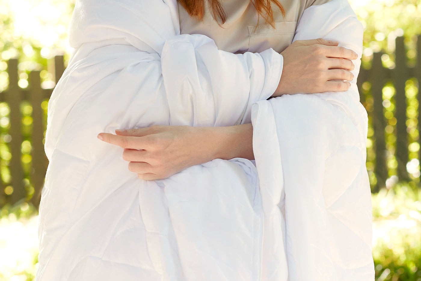 Image of a woman standing outside wrapped in the Duvet Insert + Soft Touch