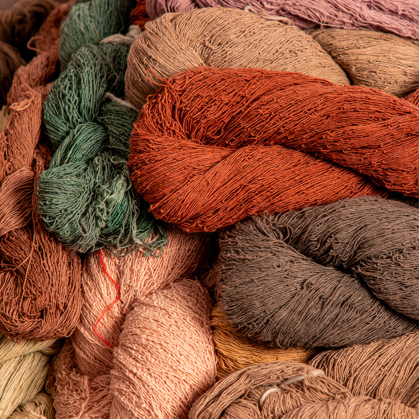Image of various colors of naturally-dyed yarn