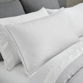Image of a Cooling Down Pillow on a gray and white bed